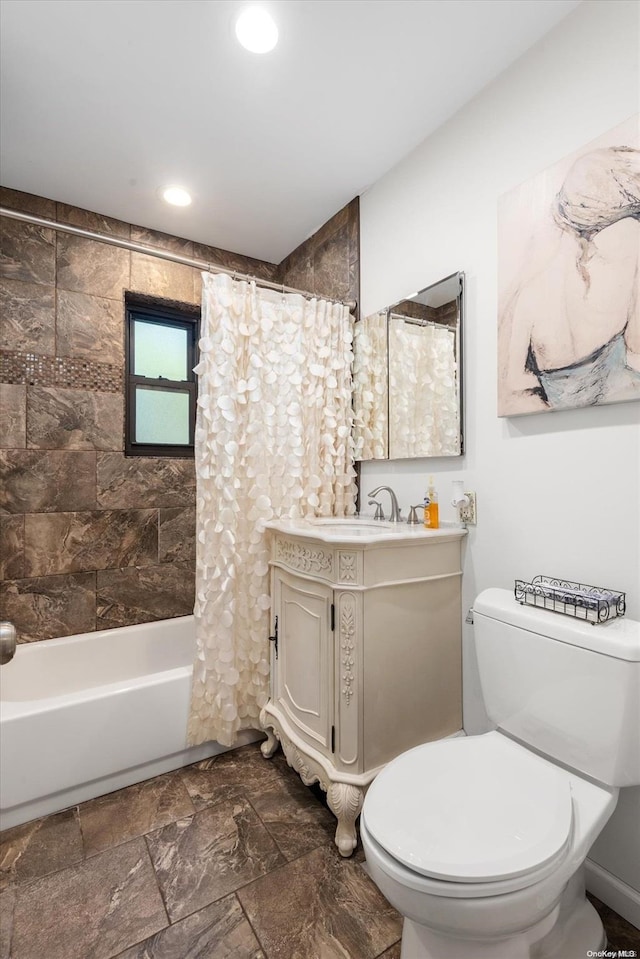 full bathroom with vanity, shower / bath combo, and toilet