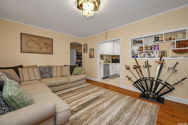 living room featuring ornamental molding and light wood-type flooring