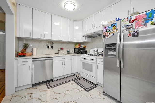 kitchen with decorative backsplash, sink, white cabinetry, and stainless steel appliances