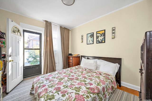 bedroom with wood-type flooring and ornamental molding