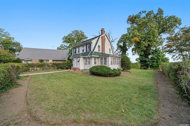 193-32 Foothill Ave, Holliswood, NY 11423 - view of property exterior featuring a yard and a chimney