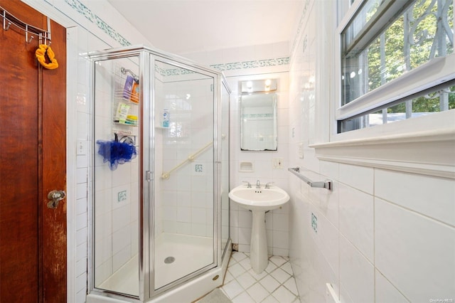 bathroom featuring an enclosed shower and tile walls