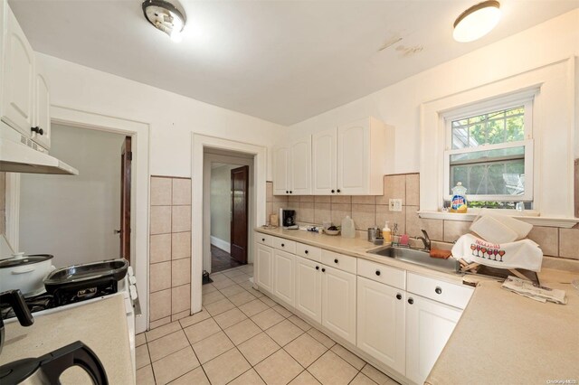 193-32 Foothill Ave, Holliswood, NY 11423 - kitchen with a sink, light tile patterned floors, light countertops, and white cabinets