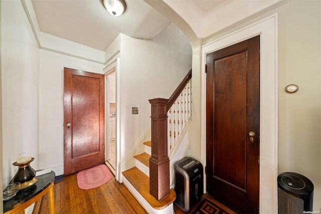 foyer entrance featuring dark hardwood / wood-style floors and heating unit