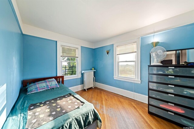 193-32 Foothill Ave, Holliswood, NY 11423 - bedroom with radiator heating unit, wood-type flooring, and baseboards