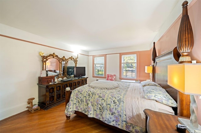 bedroom with hardwood / wood-style flooring