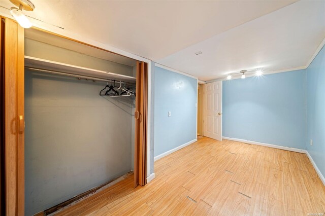 193-32 Foothill Ave, Holliswood, NY 11423 - unfurnished bedroom featuring wood finished floors, a closet, and baseboards