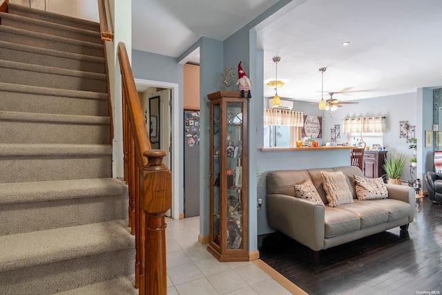 living room featuring ceiling fan and light hardwood / wood-style flooring