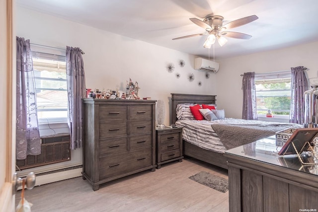 bedroom featuring a wall unit AC, ceiling fan, and light hardwood / wood-style floors