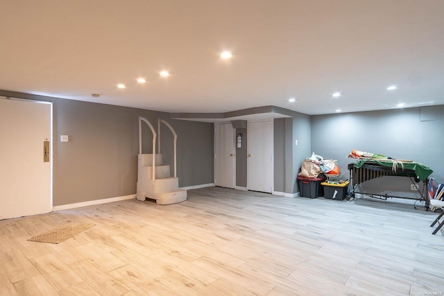 basement with light hardwood / wood-style floors