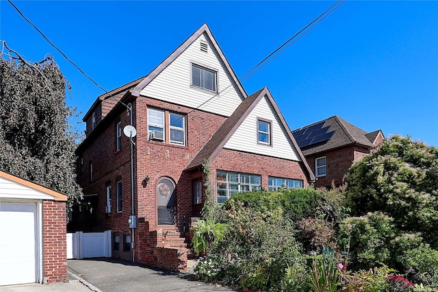 front of property featuring a garage and cooling unit