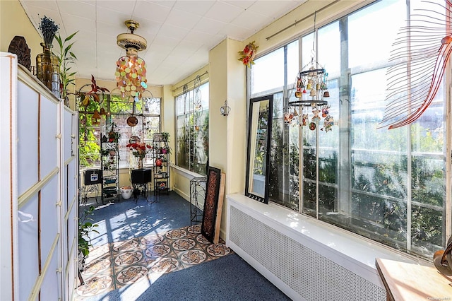 unfurnished sunroom featuring radiator