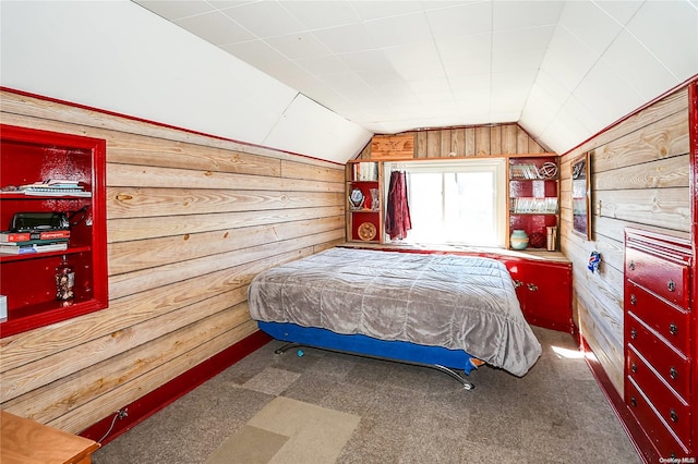 bedroom featuring dark colored carpet, lofted ceiling, and wooden walls