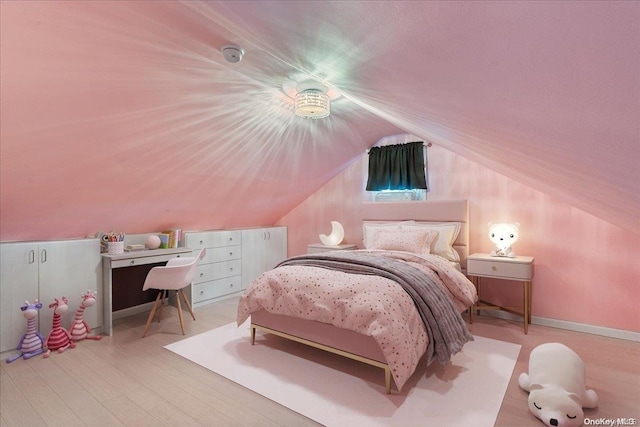 bedroom with wood-type flooring and vaulted ceiling