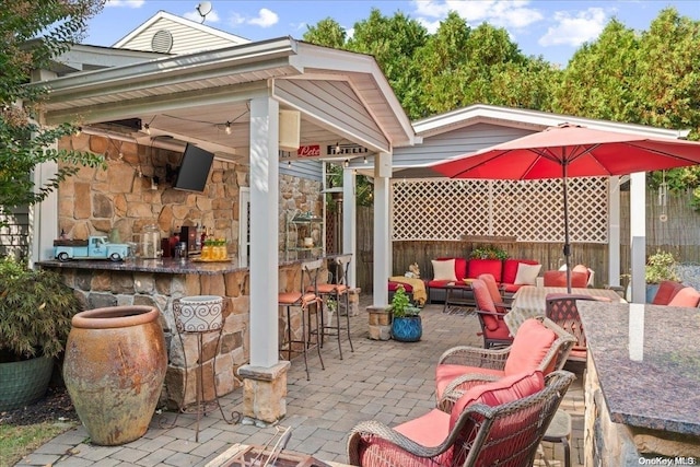 view of patio featuring an outdoor hangout area and an outdoor bar