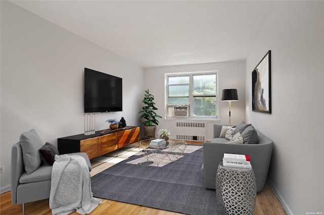 living room featuring hardwood / wood-style floors and radiator