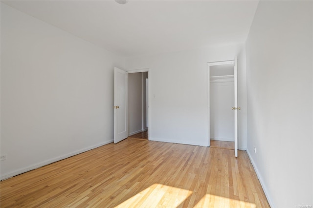 unfurnished bedroom with a closet and light hardwood / wood-style flooring