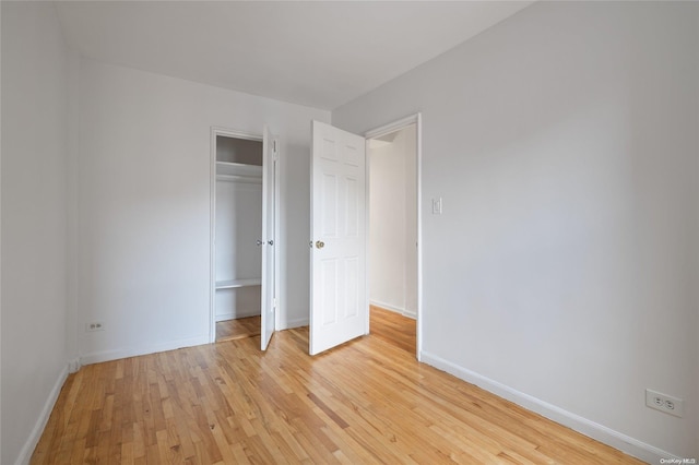 unfurnished bedroom with light wood-type flooring