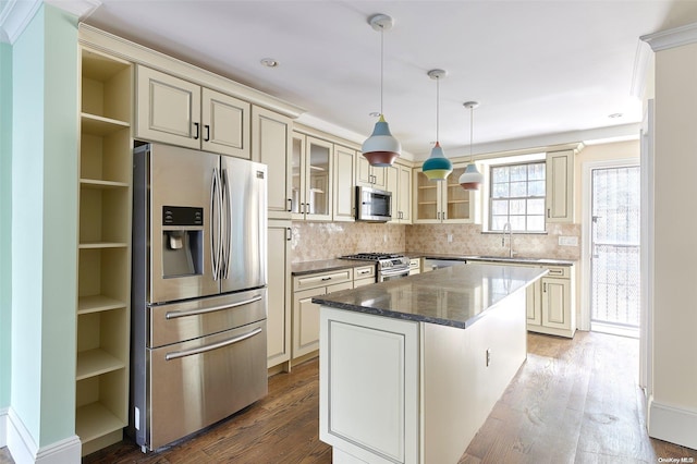 kitchen with sink, appliances with stainless steel finishes, a center island, and wood-type flooring