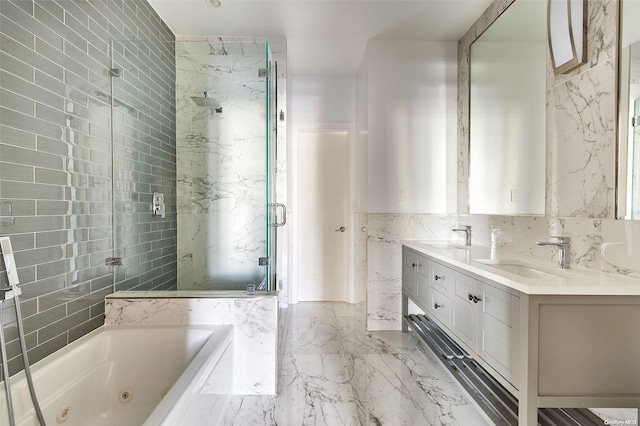 bathroom with vanity, tile walls, and shower with separate bathtub