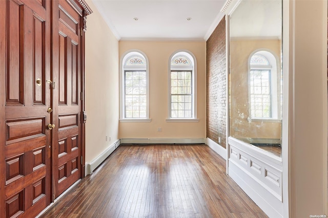 foyer featuring dark hardwood / wood-style flooring, a baseboard radiator, and ornamental molding