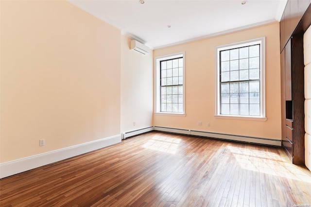 unfurnished room featuring a baseboard radiator, light hardwood / wood-style floors, a wall unit AC, and crown molding