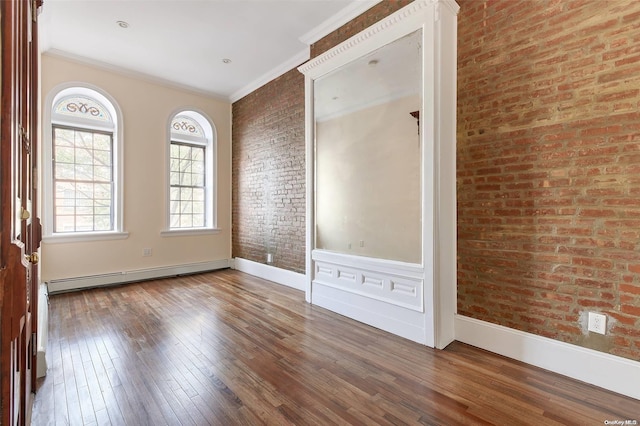 unfurnished bedroom featuring hardwood / wood-style floors, baseboard heating, and brick wall