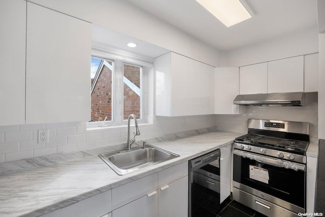 kitchen with white cabinets, stainless steel gas stove, black dishwasher, and exhaust hood