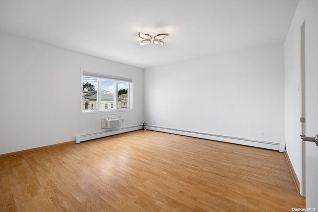 empty room featuring an AC wall unit, light hardwood / wood-style floors, and baseboard heating