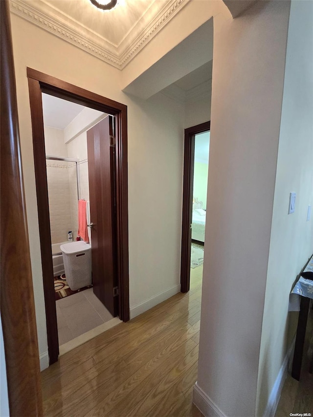 hallway featuring hardwood / wood-style floors and ornamental molding