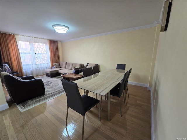 dining area featuring hardwood / wood-style floors and ornamental molding