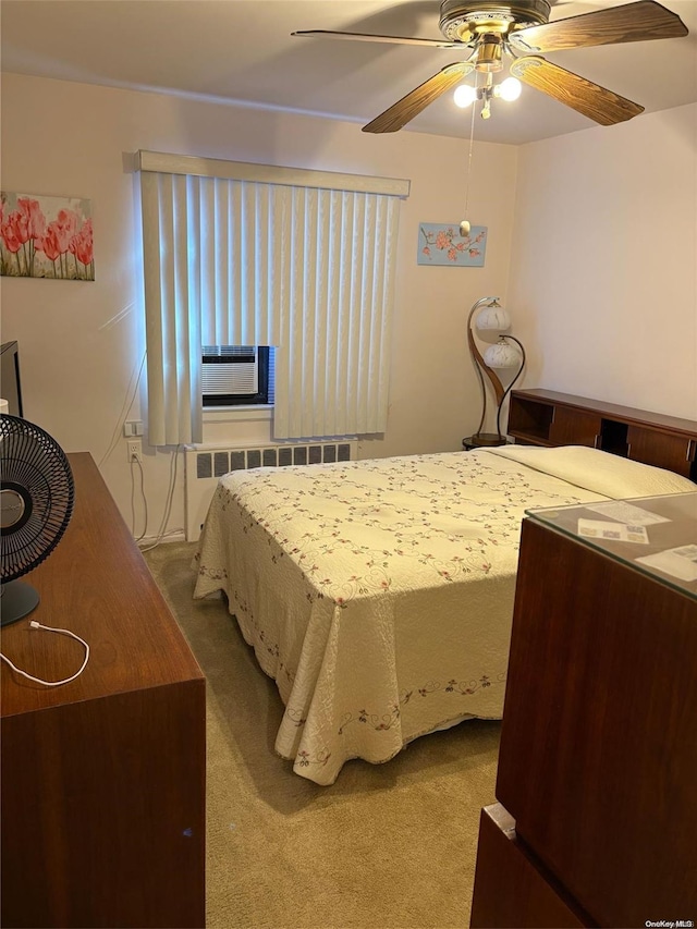 carpeted bedroom featuring radiator, ceiling fan, and cooling unit