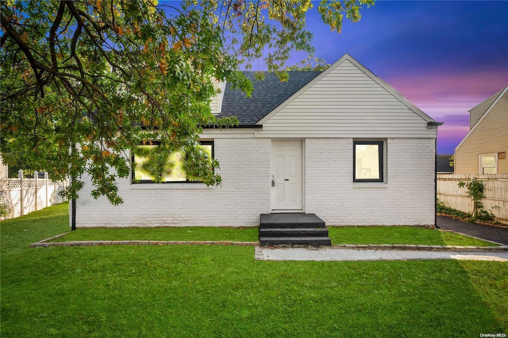 back house at dusk with a yard