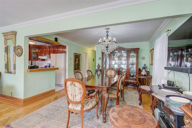 dining room featuring light parquet floors, an inviting chandelier, and ornamental molding