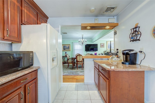 kitchen featuring white refrigerator with ice dispenser, ornamental molding, light tile patterned floors, light stone counters, and a chandelier