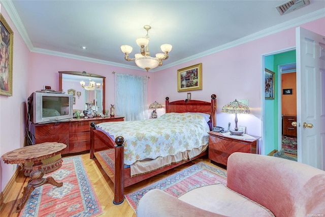 bedroom featuring light hardwood / wood-style flooring, an inviting chandelier, and ornamental molding