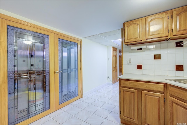 kitchen with backsplash and light tile patterned flooring