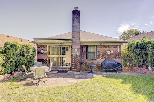 back of property featuring a patio area and a yard