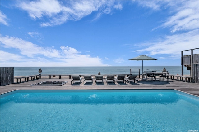 view of swimming pool featuring a deck with water view