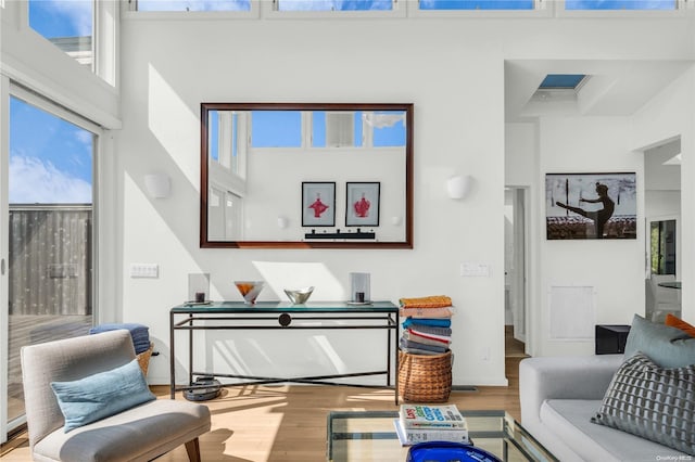 sitting room featuring hardwood / wood-style floors and a high ceiling