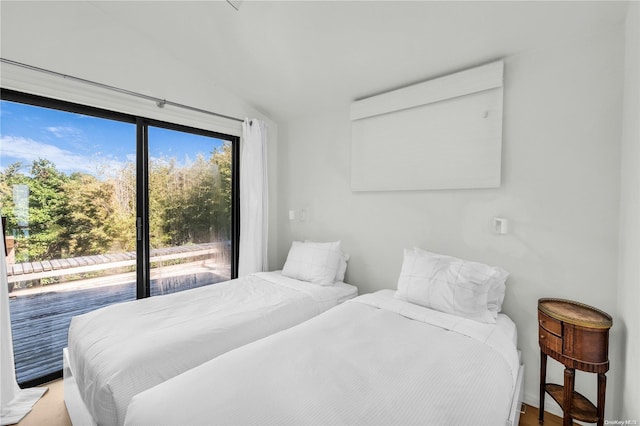 bedroom featuring hardwood / wood-style floors and lofted ceiling