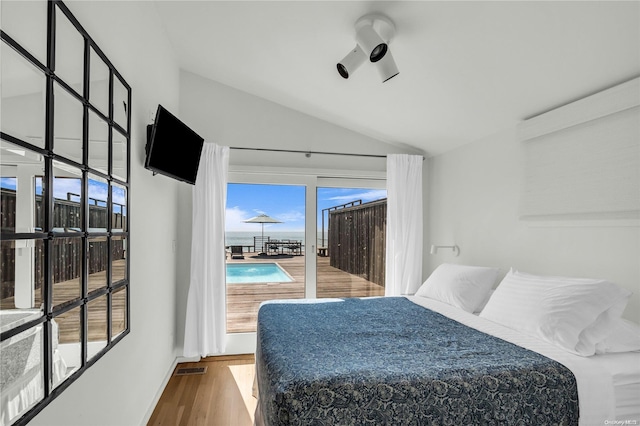 bedroom with wood-type flooring and lofted ceiling