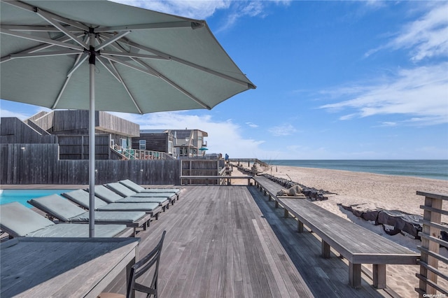 deck with a view of the beach and a water view