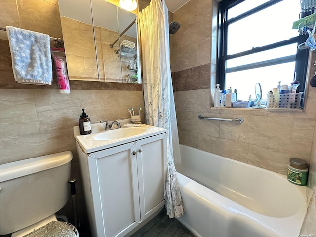 full bathroom with vanity, toilet, shower / bathtub combination with curtain, and tile walls