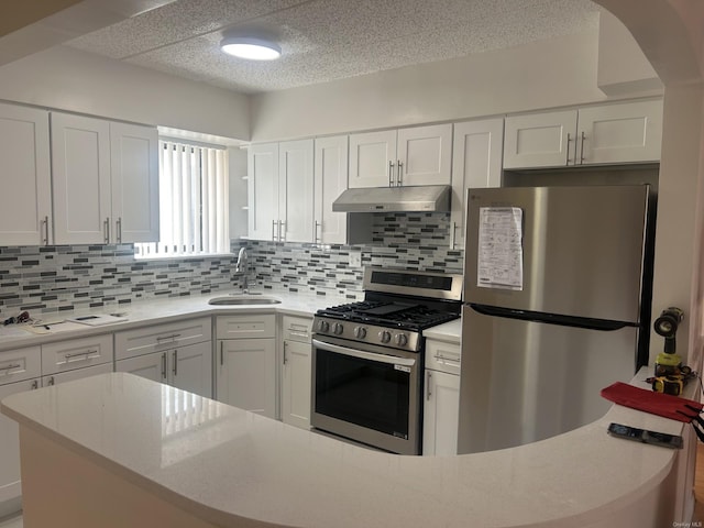 kitchen featuring white cabinets, stainless steel appliances, tasteful backsplash, and sink