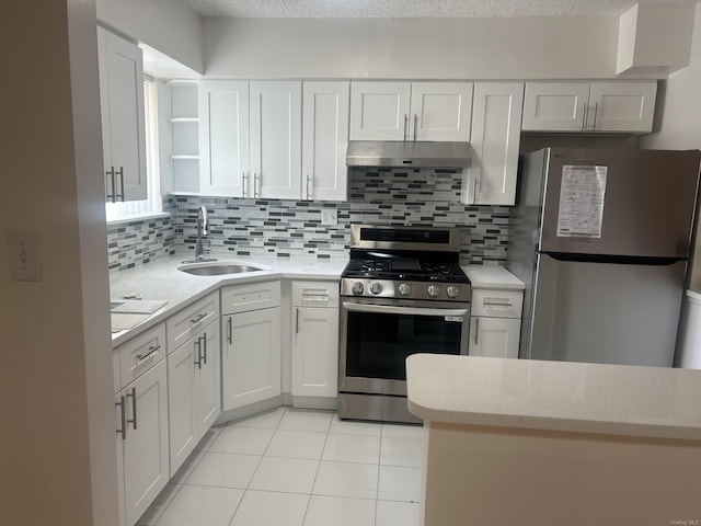 kitchen featuring tasteful backsplash, a textured ceiling, stainless steel appliances, sink, and white cabinetry