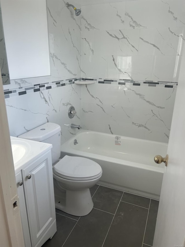 full bathroom featuring vanity, tile patterned flooring, tiled shower / bath combo, toilet, and tile walls