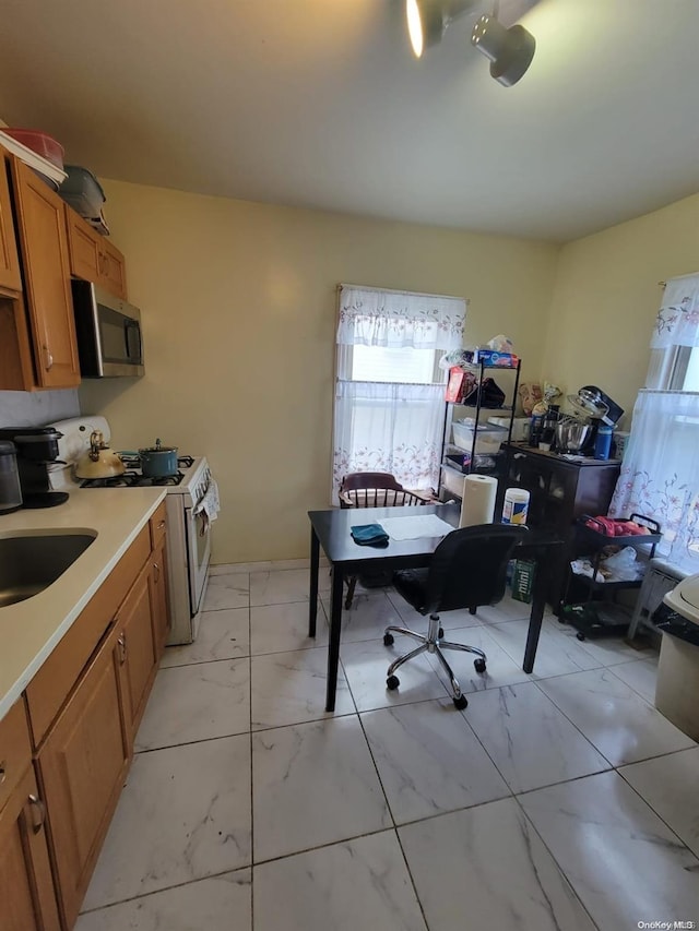 kitchen featuring white electric range oven and sink