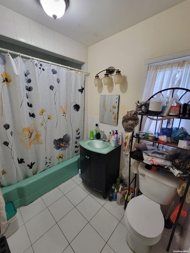 full bathroom with tile patterned floors, shower / tub combo with curtain, vanity, and toilet