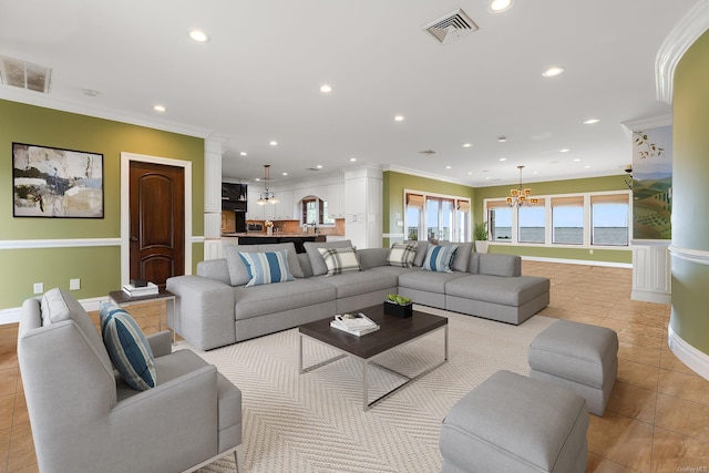 living room with a water view, crown molding, light tile patterned floors, and a notable chandelier